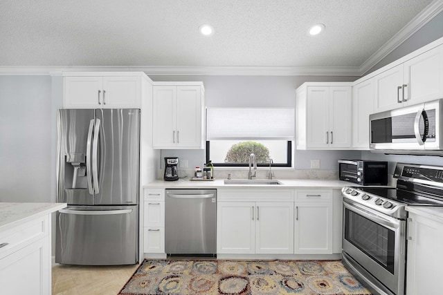 22652 Esplanada Cir W, Boca Raton, FL 33433 - kitchen featuring stainless steel appliances, a sink, ornamental molding, a textured ceiling, and white cabinets