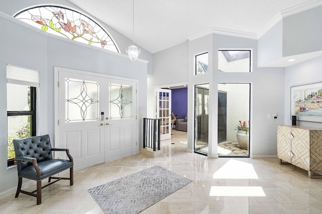 22652 Esplanada Cir W, Boca Raton, FL 33433 - foyer entrance featuring french doors, baseboards, high vaulted ceiling, crown molding, and a chandelier