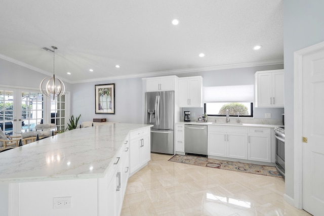 22652 Esplanada Cir W, Boca Raton, FL 33433 - kitchen with stainless steel appliances, a sink, a kitchen island, french doors, and white cabinets