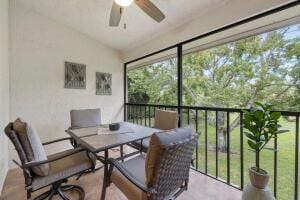 sunroom / solarium with a ceiling fan, plenty of natural light, and lofted ceiling