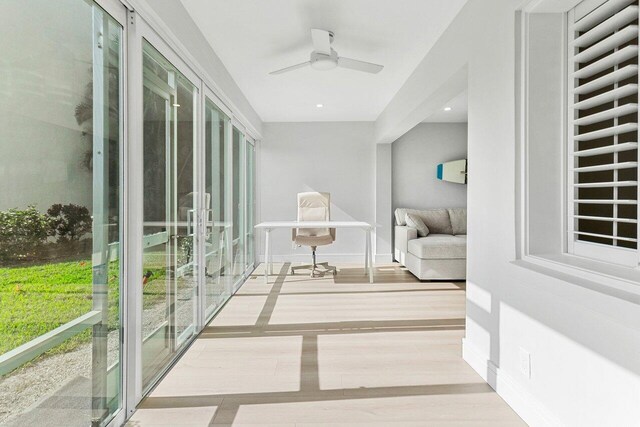 corridor with baseboards and wood finished floors