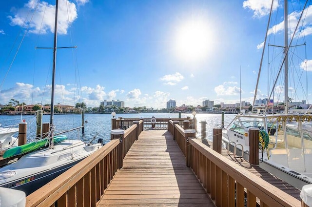view of dock with a city view and a water view