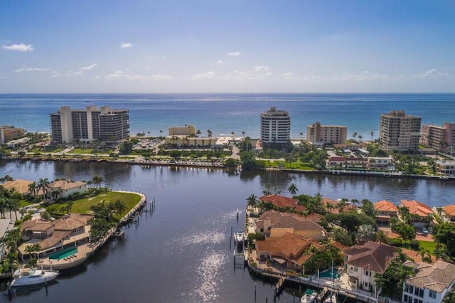 birds eye view of property featuring a city view and a water view