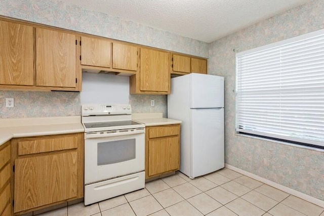 701 Sabal Ridge Cir Unit C, Palm Beach Gardens, FL 33418 - kitchen with white appliances, wallpapered walls, healthy amount of natural light, baseboards, and light countertops
