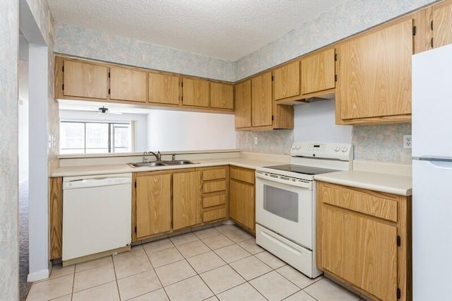 701 Sabal Ridge Cir Unit C, Palm Beach Gardens, FL 33418 - kitchen with white appliances, light countertops, a sink, a textured ceiling, and light tile patterned flooring