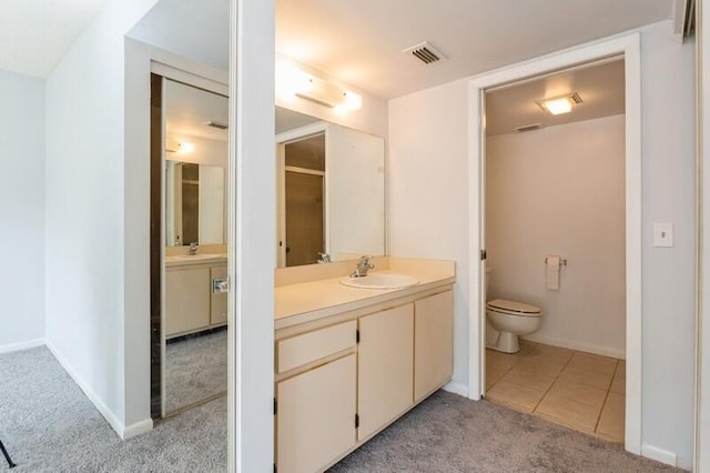 701 Sabal Ridge Cir Unit C, Palm Beach Gardens, FL 33418 - bathroom with toilet, vanity, baseboards, and tile patterned flooring