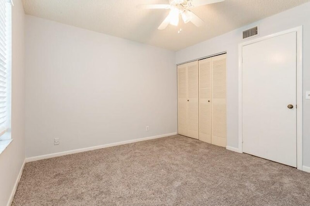 701 Sabal Ridge Cir Unit C, Palm Beach Gardens, FL 33418 - unfurnished bedroom featuring carpet floors, a closet, baseboards, and ceiling fan