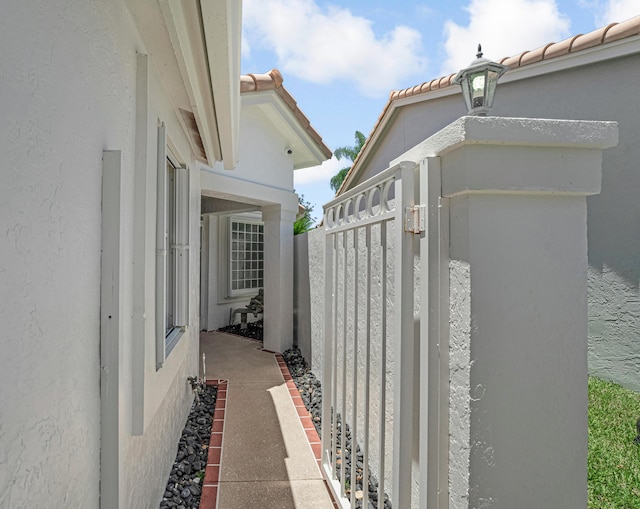 9703 Harbour Lake Cir, Boynton Beach, FL 33437 - view of home's exterior featuring stucco siding, a gate, a tiled roof, and fence