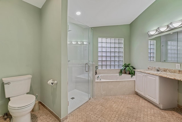 full bath featuring a shower stall, toilet, vanity, and a garden tub