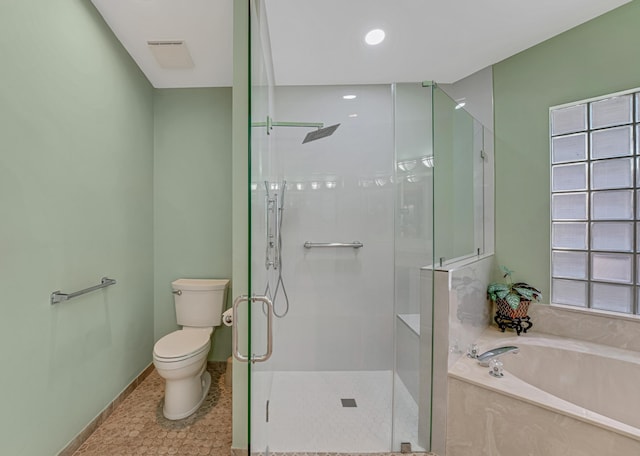 bathroom featuring a bath, a shower stall, and toilet