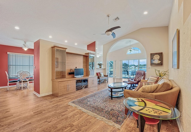 living area featuring vaulted ceiling, visible vents, recessed lighting, light wood-style floors, and ceiling fan