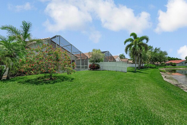 9703 Harbour Lake Cir, Boynton Beach, FL 33437 - back of house with a yard, stucco siding, and a lanai