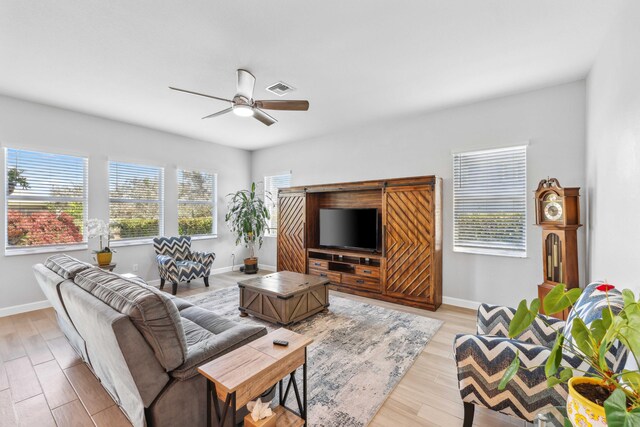 1104 Wandering Willow Way, Loxahatchee, FL 33470 - living area with a ceiling fan, baseboards, visible vents, and light wood finished floors