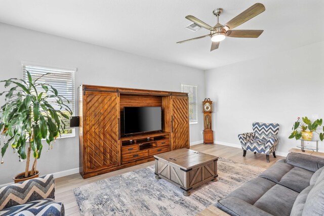 1104 Wandering Willow Way, Loxahatchee, FL 33470 - living room featuring baseboards, a ceiling fan, light wood-style flooring, and visible vents