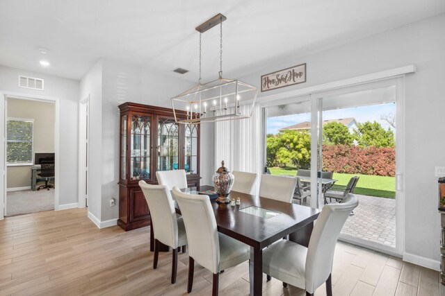 1104 Wandering Willow Way, Loxahatchee, FL 33470 - dining room featuring an inviting chandelier, baseboards, light wood-type flooring, and visible vents