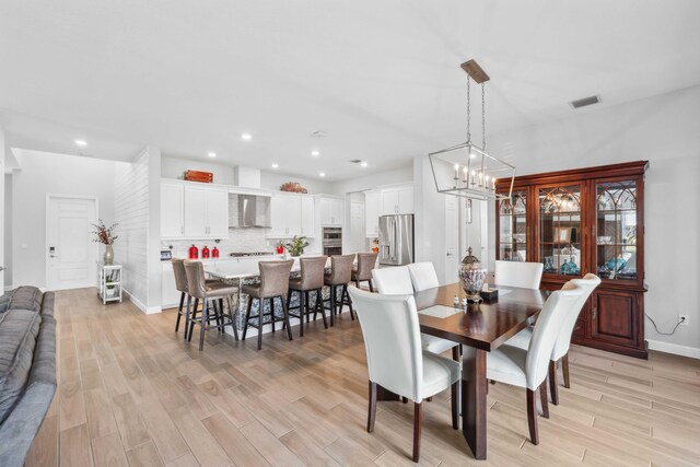 1104 Wandering Willow Way, Loxahatchee, FL 33470 - dining area with light wood-style floors, a chandelier, recessed lighting, baseboards, and visible vents