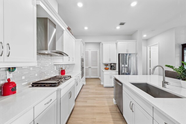 1104 Wandering Willow Way, Loxahatchee, FL 33470 - kitchen featuring wall chimney range hood, recessed lighting, light countertops, a sink, and appliances with stainless steel finishes