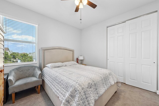 1104 Wandering Willow Way, Loxahatchee, FL 33470 - bedroom featuring light colored carpet, ceiling fan, and a closet