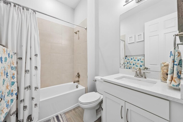 1104 Wandering Willow Way, Loxahatchee, FL 33470 - bathroom featuring vanity, shower / bath combo with shower curtain, toilet, and wood finished floors