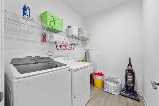 1104 Wandering Willow Way, Loxahatchee, FL 33470 - laundry room featuring laundry area, washer and clothes dryer, baseboards, and wood finished floors