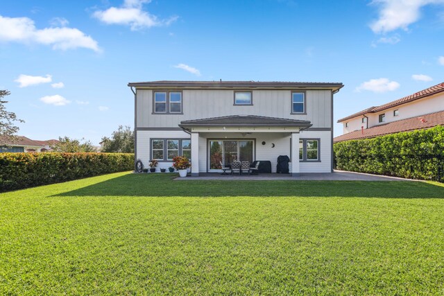 1104 Wandering Willow Way, Loxahatchee, FL 33470 - rear view of house featuring a lawn and a patio area