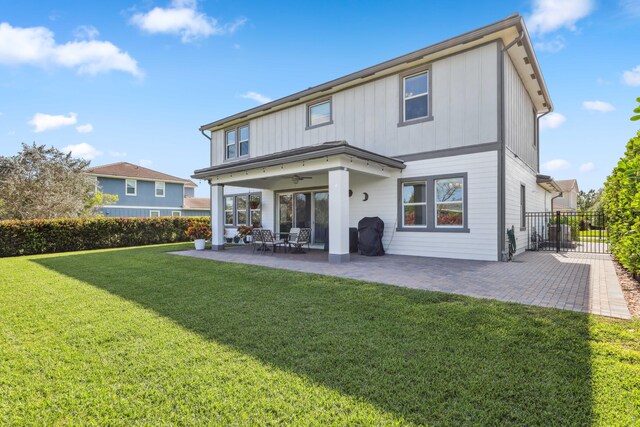 1104 Wandering Willow Way, Loxahatchee, FL 33470 - back of property featuring fence, board and batten siding, ceiling fan, a patio, and a yard