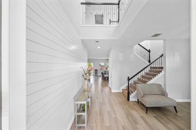 1104 Wandering Willow Way, Loxahatchee, FL 33470 - entrance foyer with a high ceiling, baseboards, wood finished floors, visible vents, and stairway