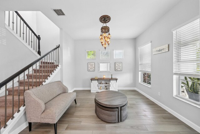 1104 Wandering Willow Way, Loxahatchee, FL 33470 - living area featuring baseboards, stairs, wood finished floors, and visible vents