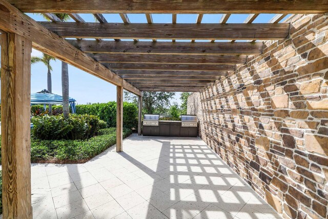 1104 Wandering Willow Way, Loxahatchee, FL 33470 - view of patio with exterior kitchen, a pergola, and a grill