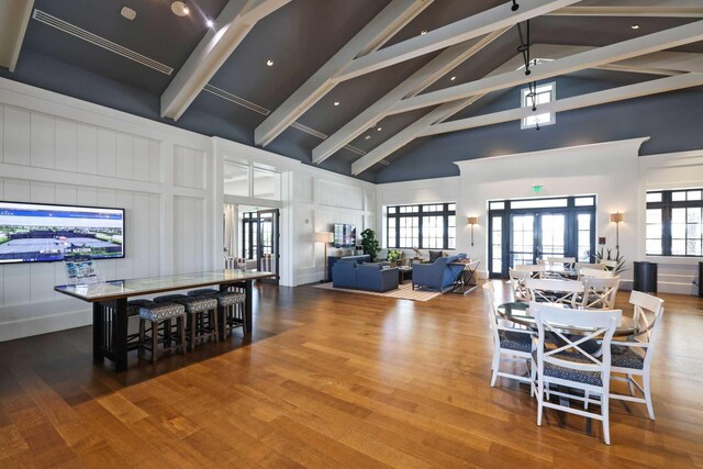 1104 Wandering Willow Way, Loxahatchee, FL 33470 - dining space with beam ceiling, a decorative wall, high vaulted ceiling, french doors, and wood finished floors