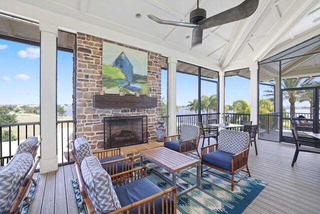 1104 Wandering Willow Way, Loxahatchee, FL 33470 - sunroom / solarium featuring a ceiling fan, an outdoor living space with a fireplace, beam ceiling, and a water view