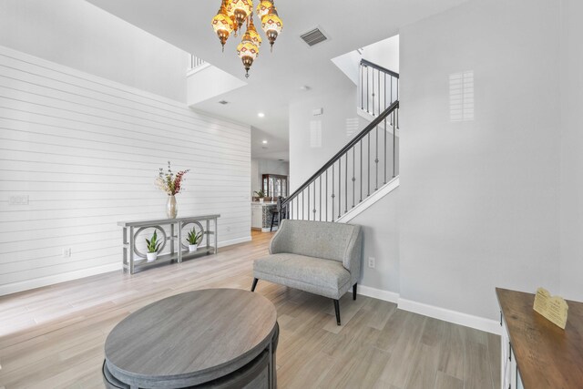 1104 Wandering Willow Way, Loxahatchee, FL 33470 - living area featuring a notable chandelier, baseboards, visible vents, and light wood-style flooring