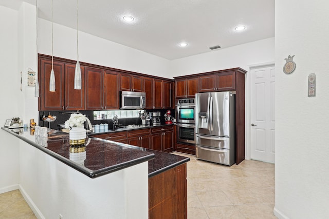 1070 Grove Park Cir, Boynton Beach, FL 33436 - kitchen featuring stainless steel appliances, a peninsula, light tile patterned flooring, recessed lighting, and pendant lighting
