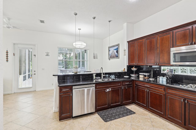 1070 Grove Park Cir, Boynton Beach, FL 33436 - kitchen featuring stainless steel appliances, visible vents, a sink, decorative backsplash, and a peninsula