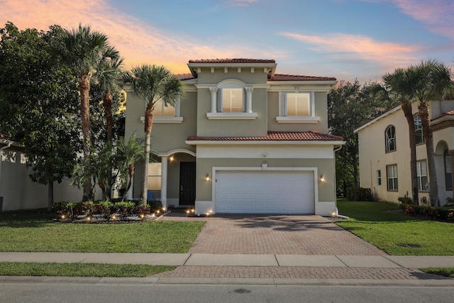 1070 Grove Park Cir, Boynton Beach, FL 33436 - mediterranean / spanish house with a tile roof, decorative driveway, a garage, a front yard, and stucco siding