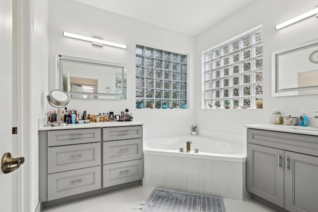 1070 Grove Park Cir, Boynton Beach, FL 33436 - full bath featuring a bath, two vanities, and tile patterned flooring