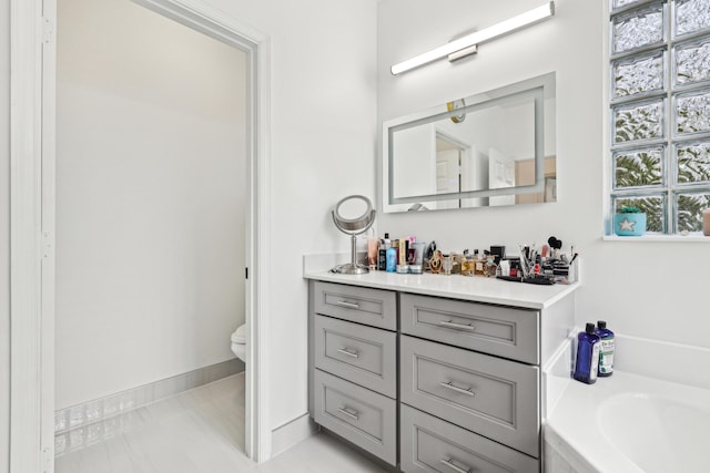 1070 Grove Park Cir, Boynton Beach, FL 33436 - full bath featuring baseboards, a bath, toilet, and vanity