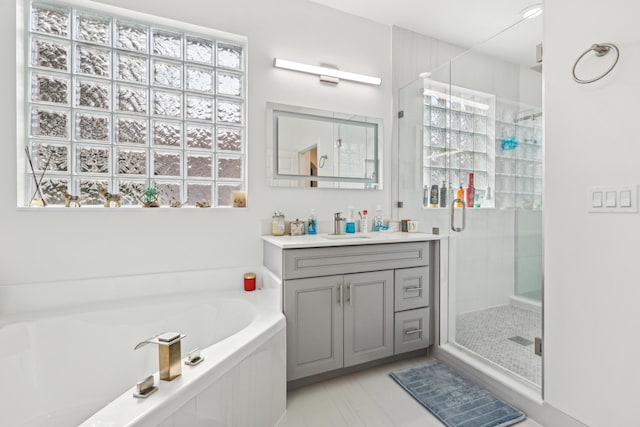 1070 Grove Park Cir, Boynton Beach, FL 33436 - full bathroom featuring a garden tub, a healthy amount of sunlight, vanity, and a stall shower