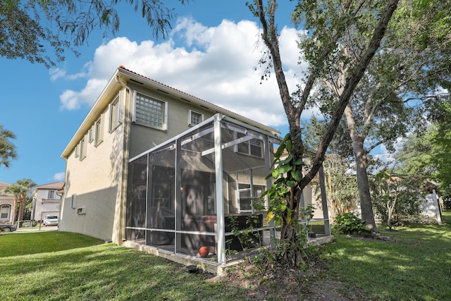 1070 Grove Park Cir, Boynton Beach, FL 33436 - exterior space featuring glass enclosure, a yard, and stucco siding