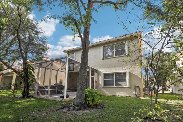 1070 Grove Park Cir, Boynton Beach, FL 33436 - back of property featuring a yard, a lanai, a patio, and stucco siding