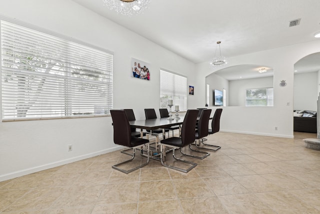 1070 Grove Park Cir, Boynton Beach, FL 33436 - dining space with arched walkways, baseboards, and light tile patterned floors