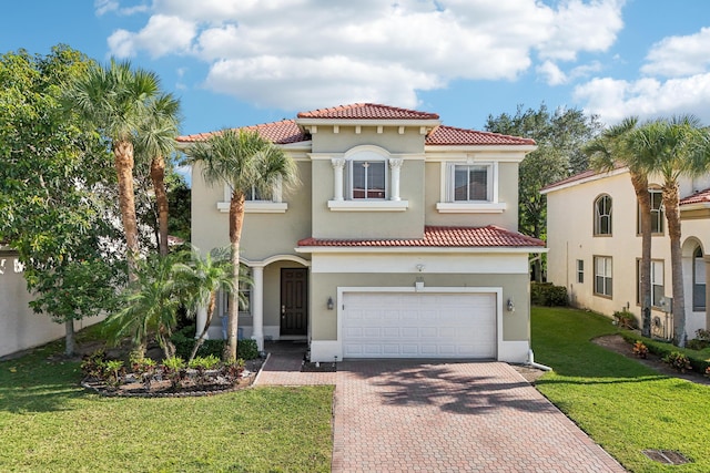 1070 Grove Park Cir, Boynton Beach, FL 33436 - mediterranean / spanish-style home featuring a tiled roof, a front lawn, stucco siding, decorative driveway, and a garage
