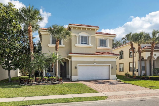 1070 Grove Park Cir, Boynton Beach, FL 33436 - mediterranean / spanish-style home featuring decorative driveway, a tiled roof, a front yard, a garage, and stucco siding