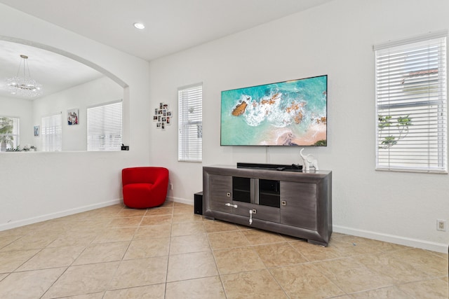 1070 Grove Park Cir, Boynton Beach, FL 33436 - sitting room with arched walkways, tile patterned floors, baseboards, and a notable chandelier