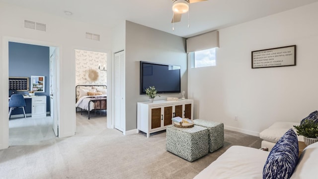 living area featuring ceiling fan, baseboards, carpet, and visible vents