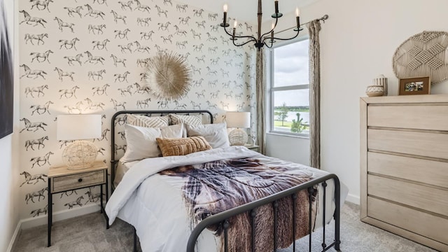 bedroom featuring baseboards, carpet flooring, and a notable chandelier