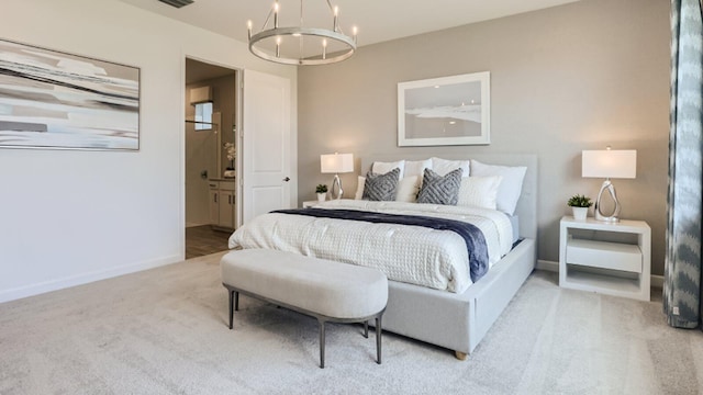 bedroom with an inviting chandelier, baseboards, ensuite bathroom, and carpet floors
