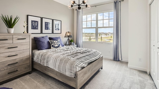 bedroom with light colored carpet, multiple windows, a notable chandelier, and baseboards