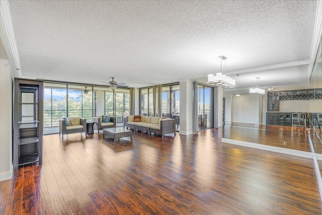 7572 Regency Lake Dr Unit 501, Boca Raton, FL 33433 - living room featuring a textured ceiling, a chandelier, crown molding, wood finished floors, and ceiling fan