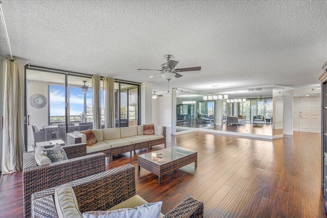 7572 Regency Lake Dr Unit 501, Boca Raton, FL 33433 - living room with a textured ceiling, a ceiling fan, wood finished floors, and baseboards